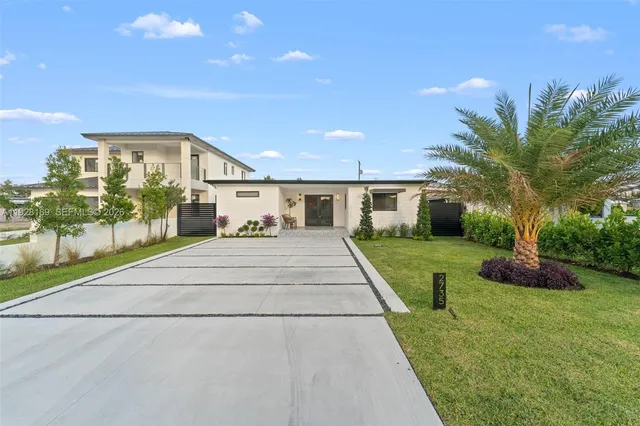 a view of house with yard and green space
