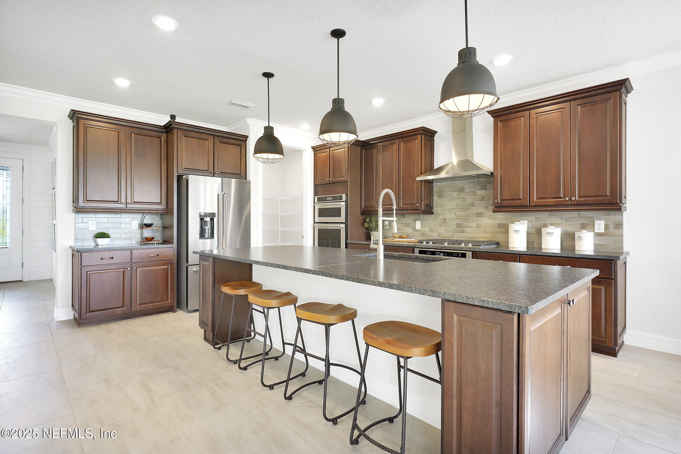 334 Continuum Loop Yulee, FL 32097 - Photo 4 of 37 a kitchen with stainless steel appliances granite countertop a refrigerator a sink dishwasher a stove and white cabinets with wooden floor