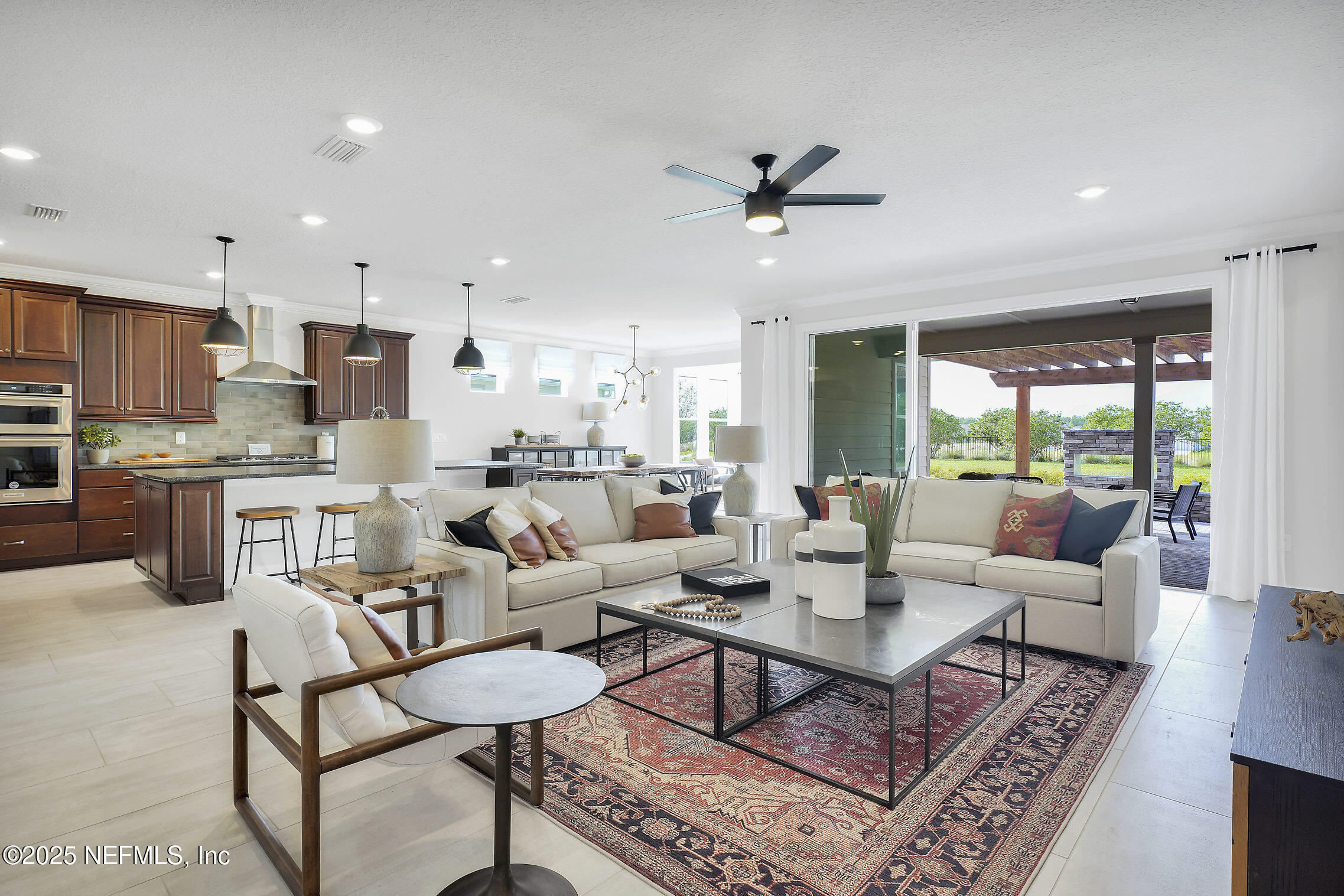 334 Continuum Loop Yulee, FL 32097 - Photo 8 of 37 a living room with kitchen view and a dining table with kitchen view