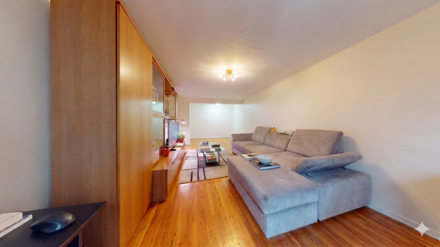 1200 Gravesend Neck Road, Unit 3L Brooklyn, NY 11229 - Photo 7 of 10 a living room with furniture and a wooden floor