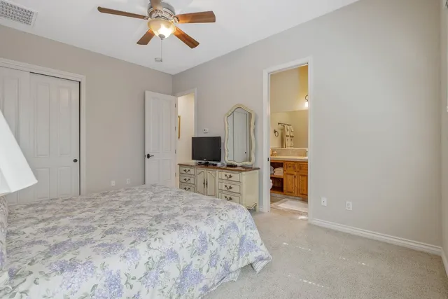 a dining room with wooden floor a chandelier a wooden table and chairs