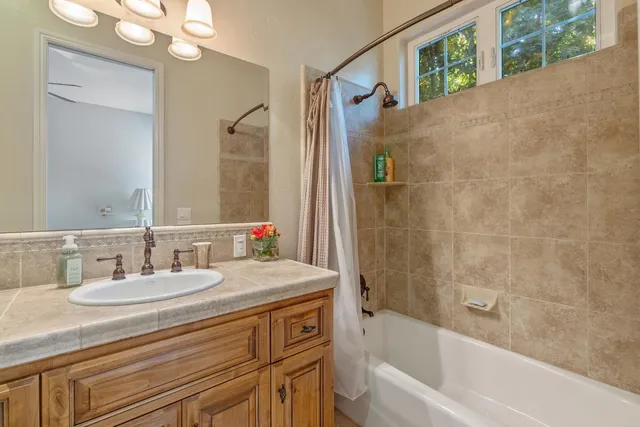 a view of a hallway with furniture and a chandelier