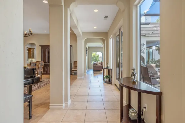 a dining room with furniture a painting and a chandelier