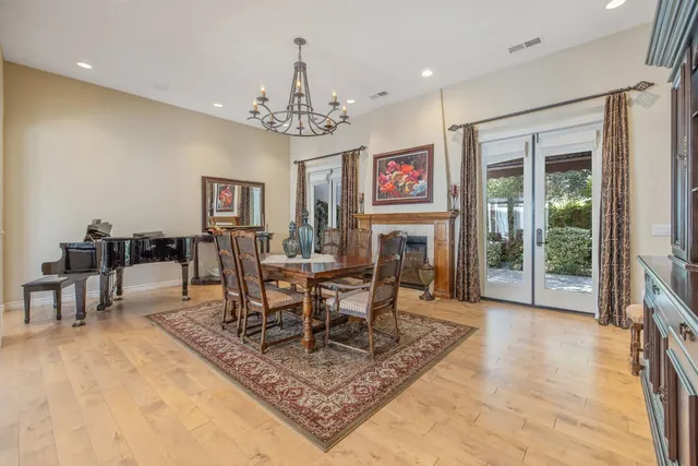 a large kitchen with kitchen island granite countertop a large counter top a sink a stove a window and stainless steel appliances