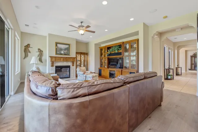 a dining room with furniture and a floor to ceiling window