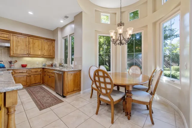 a view of a bathroom with sink mirror and window