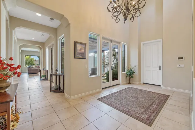 a bedroom with a large bed and a chandelier