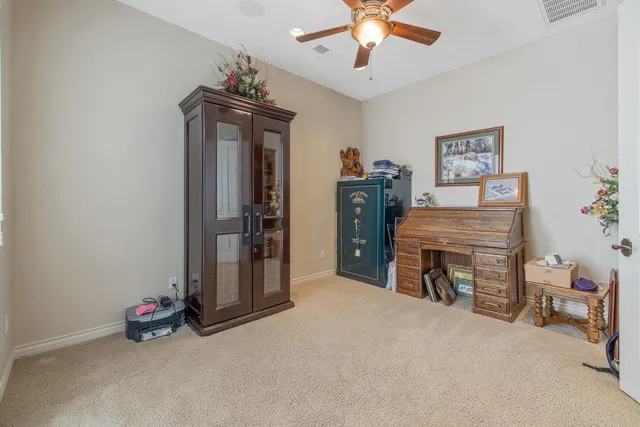 a bathroom with a granite countertop toilet sink and mirror