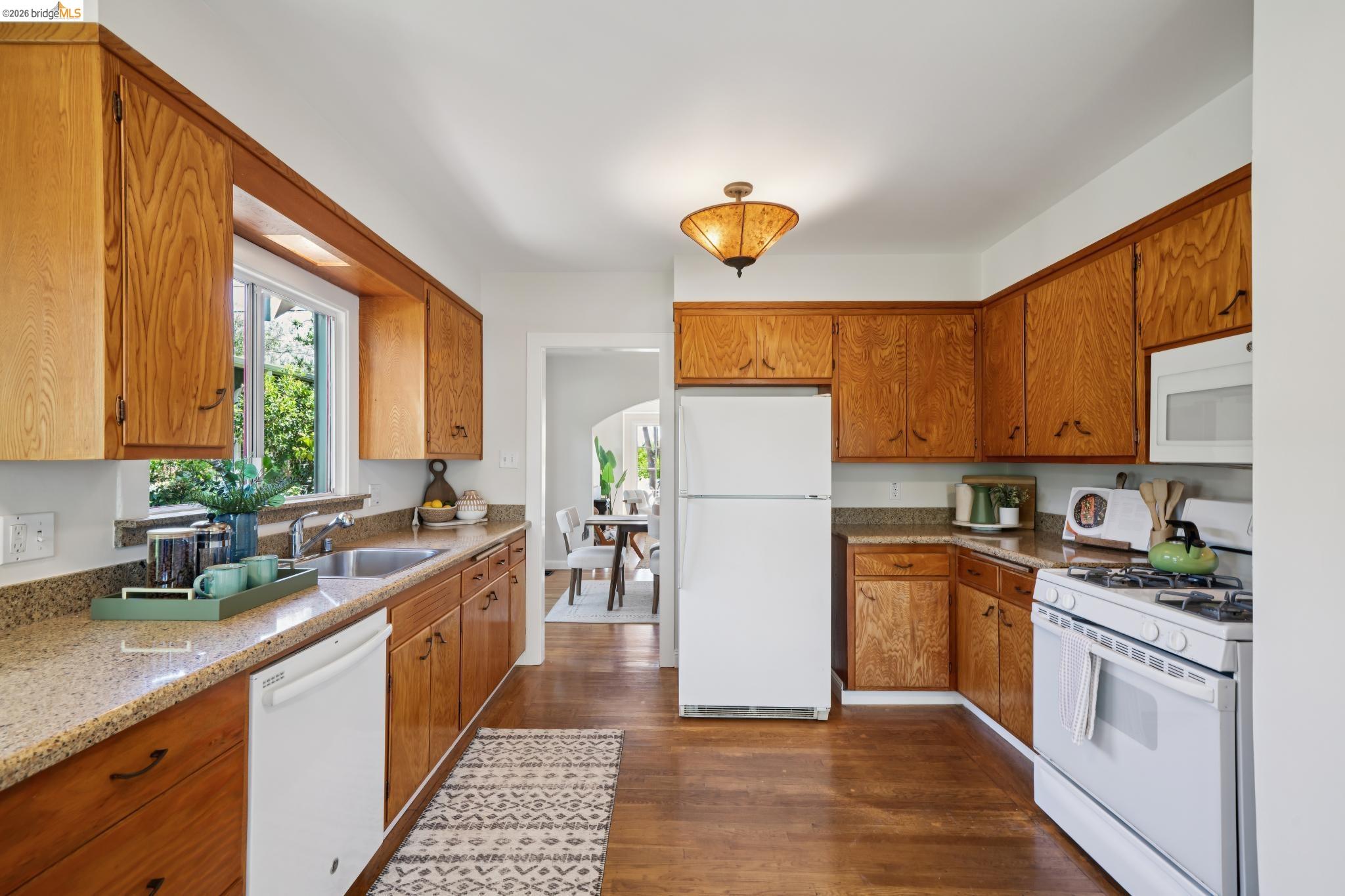 1425 Virginia Street Berkeley, CA 94702 - Photo 16 of 42 a kitchen with a sink a refrigerator and cabinets