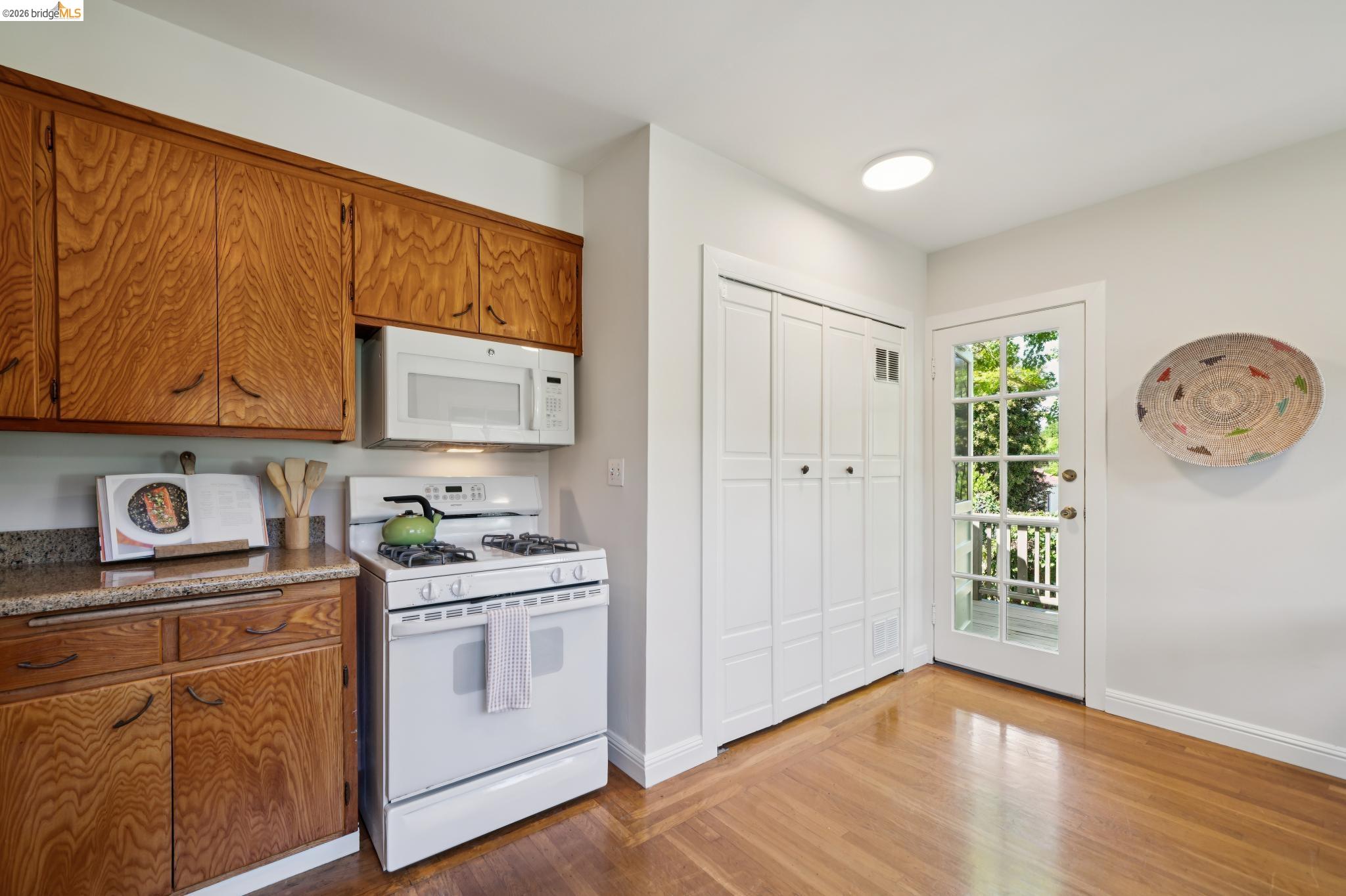 1425 Virginia Street Berkeley, CA 94702 - Photo 17 of 42 a kitchen with stainless steel appliances granite countertop a sink a stove and cabinets