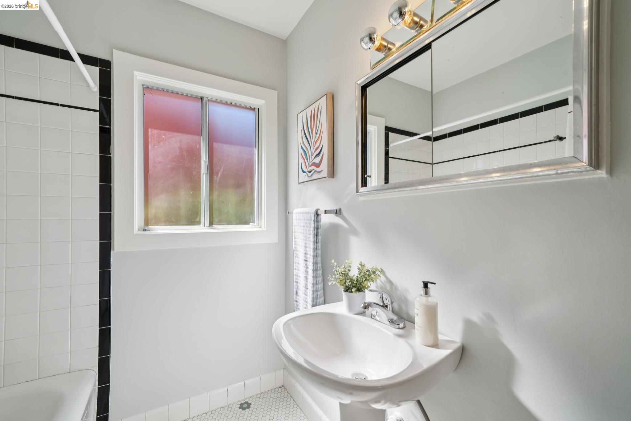 1425 Virginia Street Berkeley, CA 94702 - Photo 23 of 42 a bathroom with a sink and a mirror