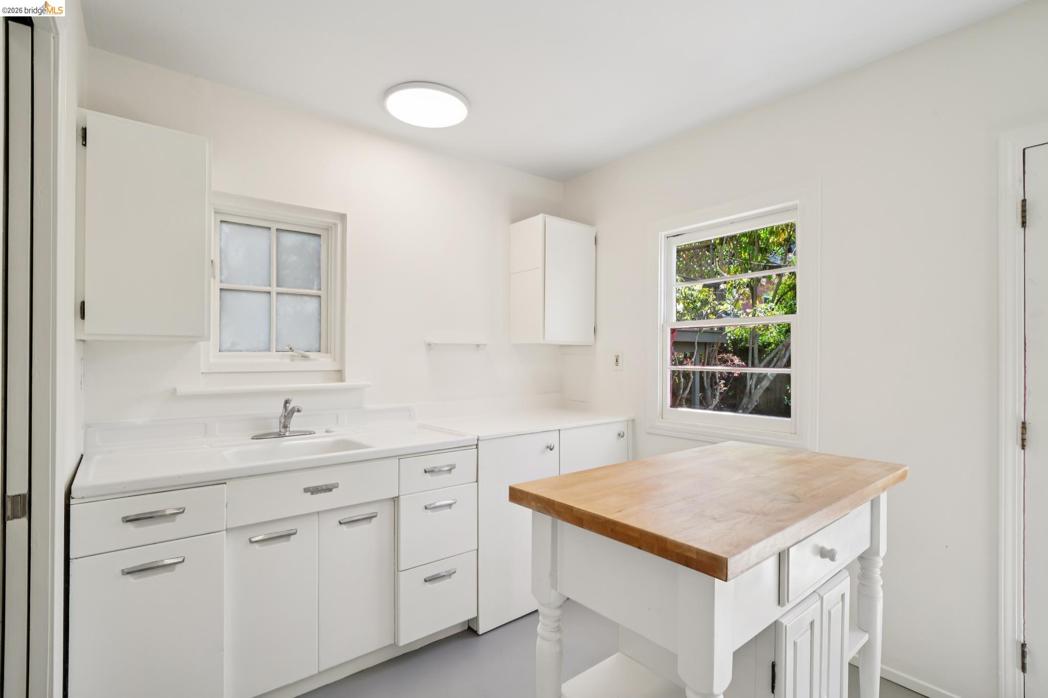 1425 Virginia Street Berkeley, CA 94702 - Photo 35 of 42 a kitchen with a sink cabinets and wooden floor