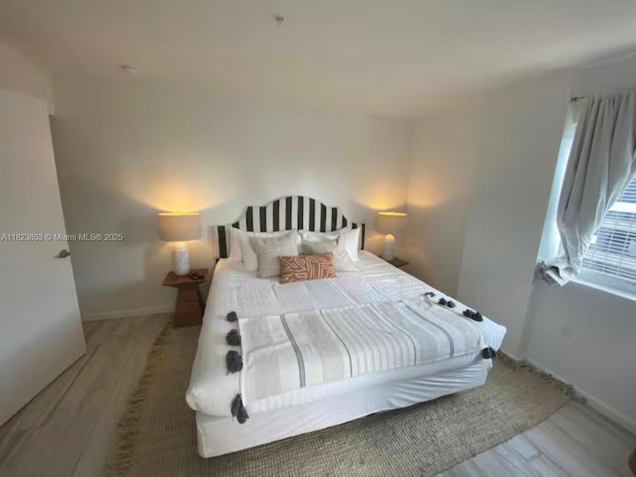 481 Northeast 29th Street, Unit 706 Miami, FL 33137 - Photo 24 of 26 a bed sitting in a bedroom next to a window