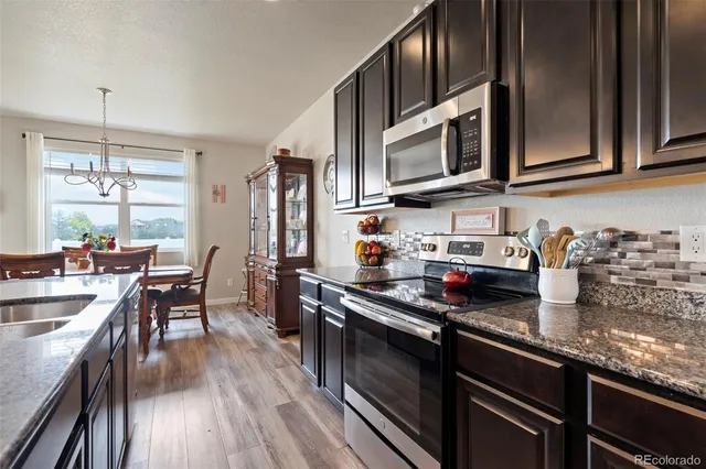 a kitchen with stainless steel appliances granite countertop counter space a sink and cabinets
