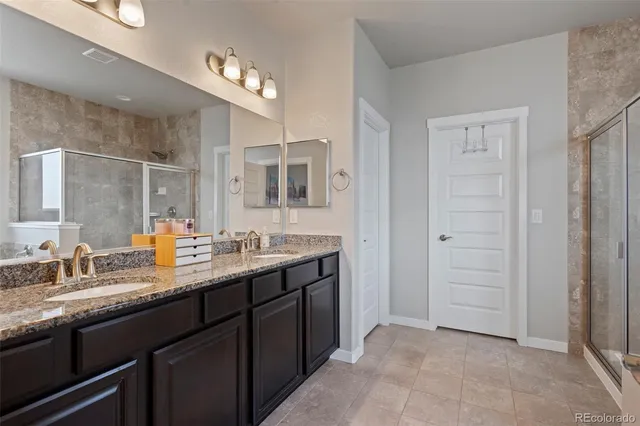 a bathroom with a granite countertop sink a mirror and a
