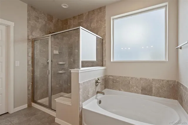 a bathroom with a bathtub and a shower