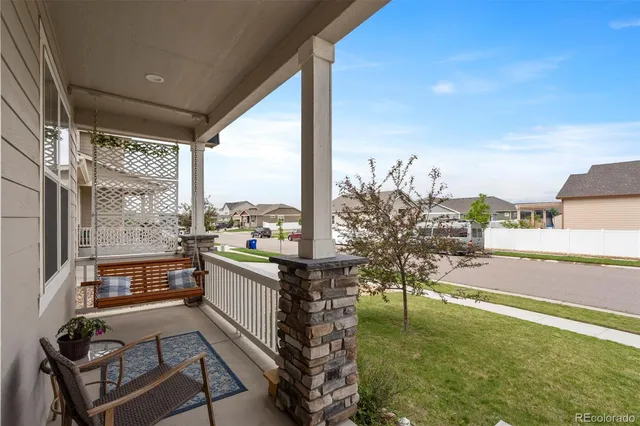 a view of a porch with furniture and garden