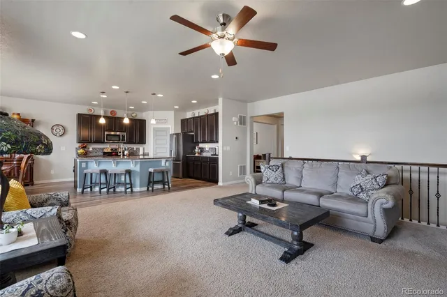 a living room with furniture and kitchen view