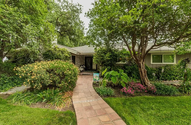 an aerial view of a house with a yard and swimming pool