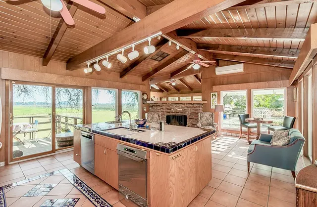 a living room with furniture a window and a flat screen tv