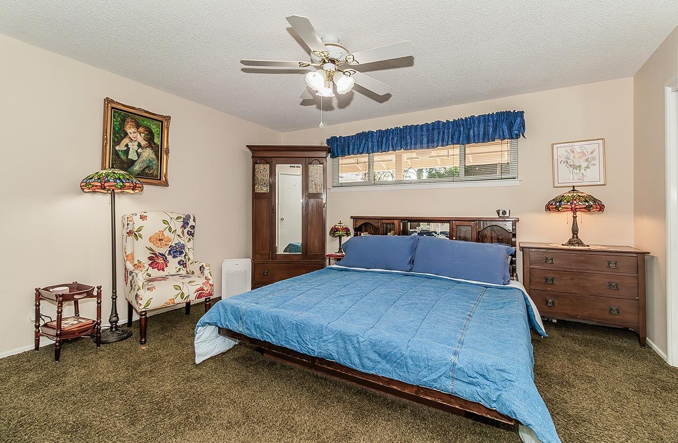 3670 South Newmark Avenue Sanger, CA 93657 - Photo 26 of 98 a bed room with a bed and a ceiling fan