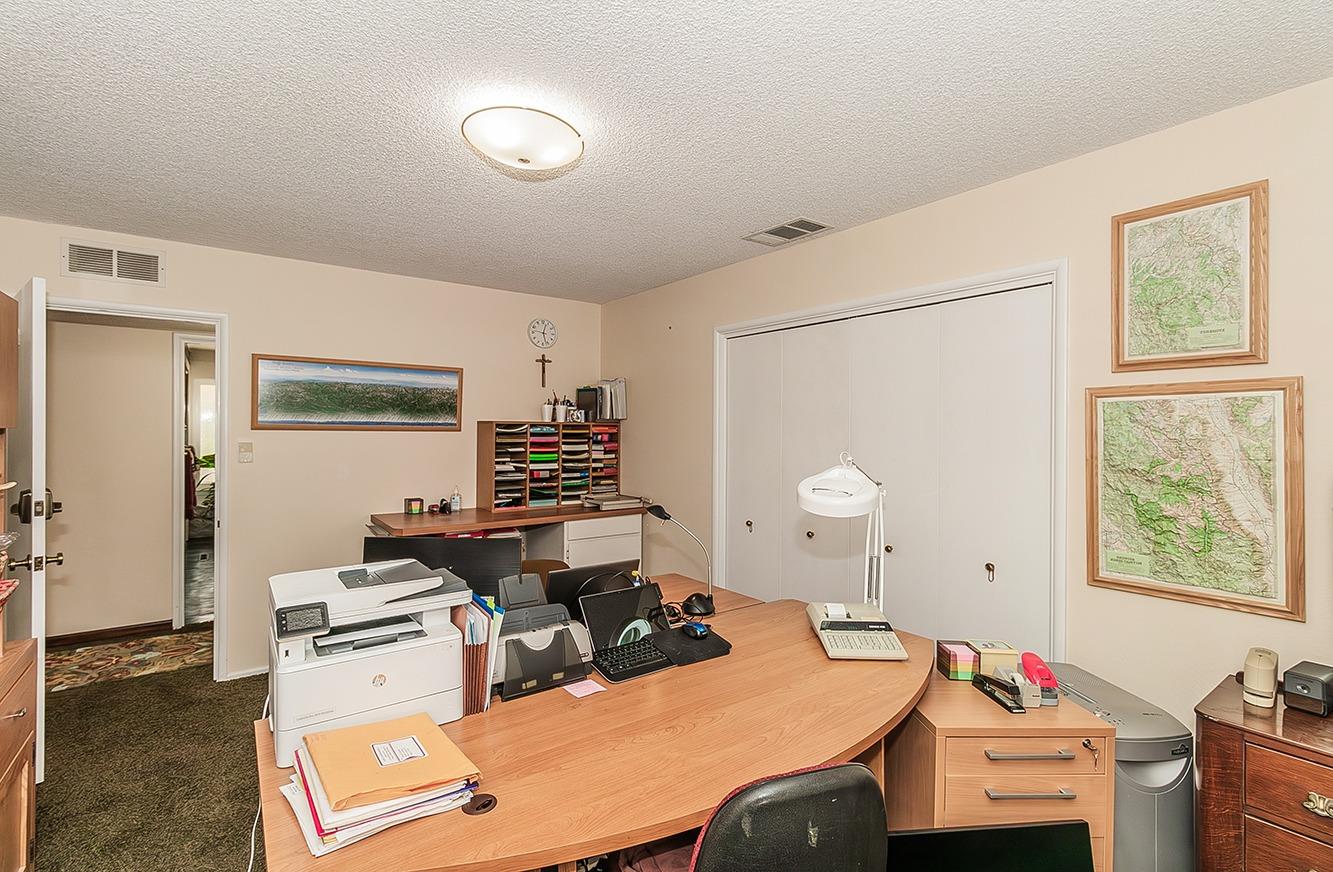 3670 South Newmark Avenue Sanger, CA 93657 - Photo 30 of 98 a room with a desk chairs and white appliances