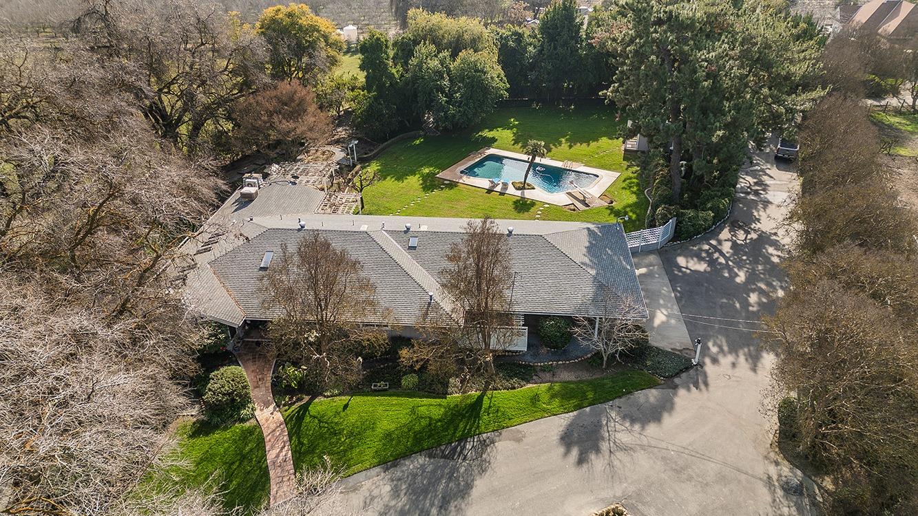 3670 South Newmark Avenue Sanger, CA 93657 - Photo 4 of 98 an aerial view of a house with a yard and swimming pool