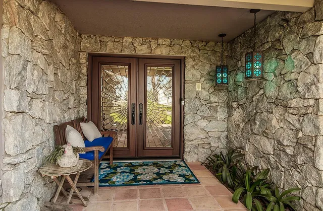 a view of a patio with table and chairs and potted plants