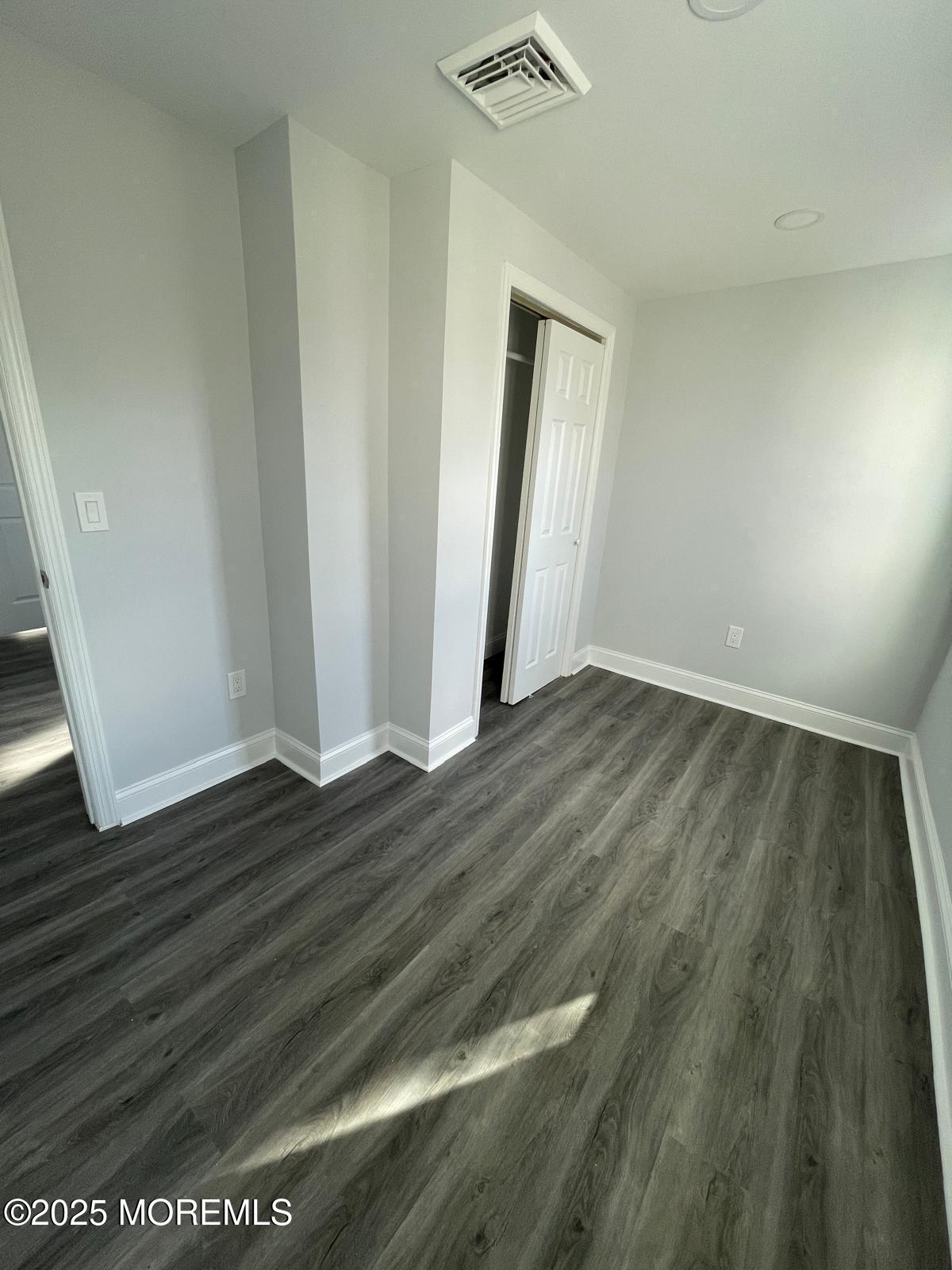 405 Myrtle Avenue Neptune Township, NJ 07753 - Photo 14 of 20 a view of an empty room with wooden floor