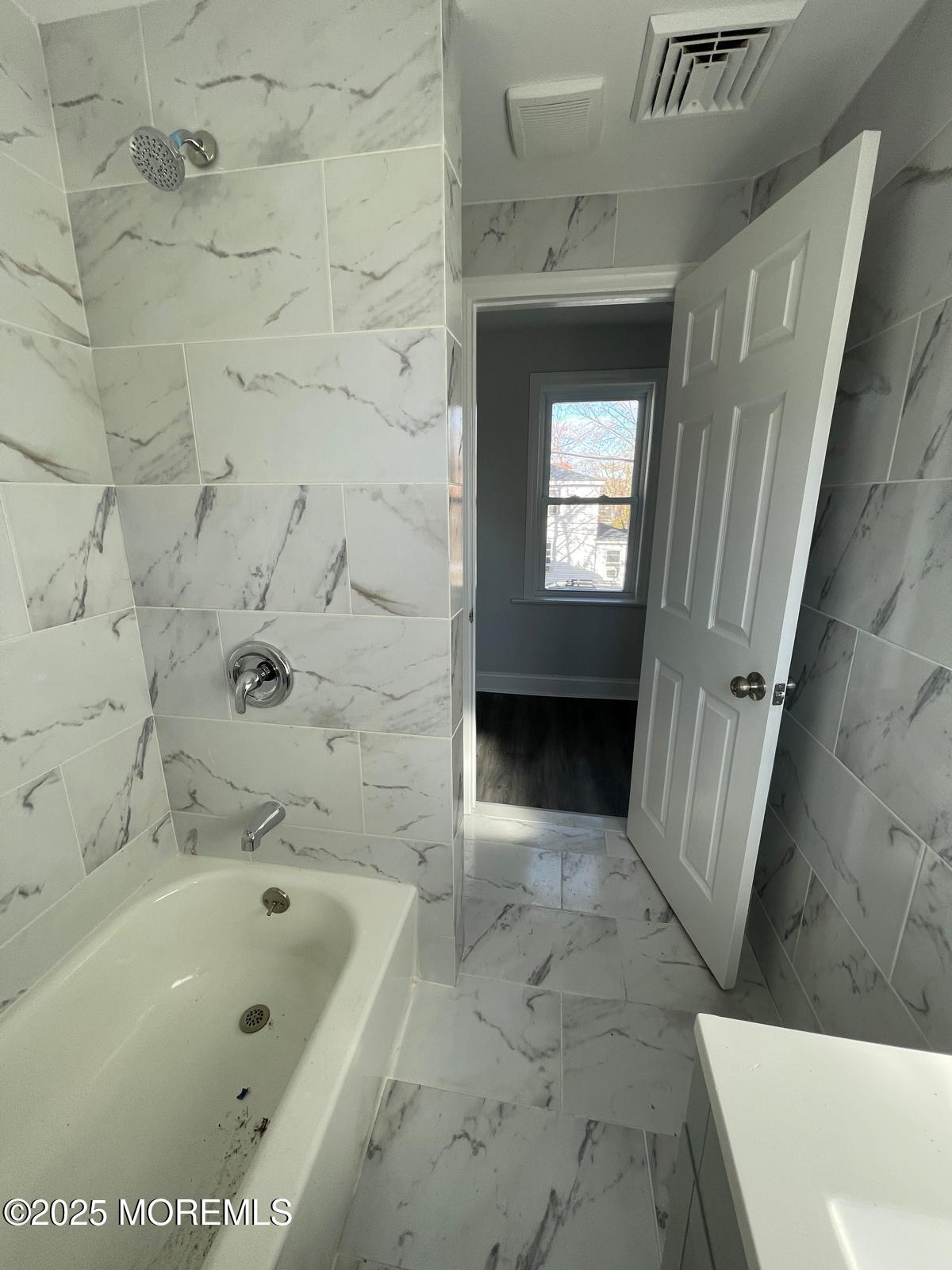 405 Myrtle Avenue Neptune Township, NJ 07753 - Photo 16 of 20 a bathroom with a bathtub and a shower