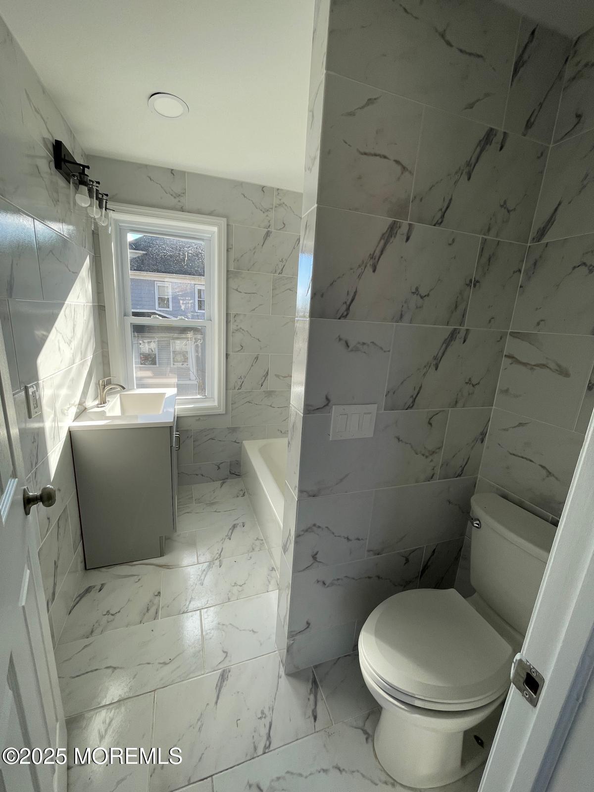 405 Myrtle Avenue Neptune Township, NJ 07753 - Photo 17 of 20 a white toilet sitting next to a bathroom sink