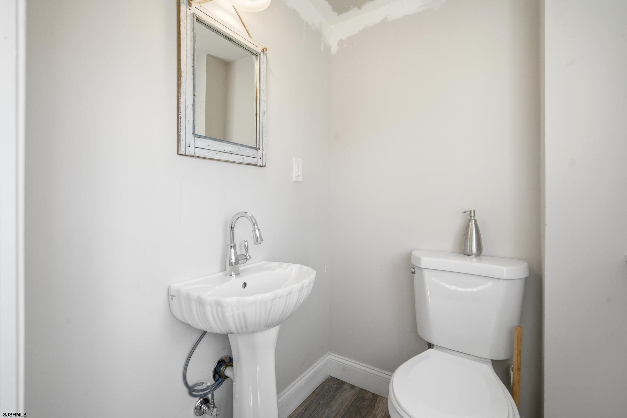 1103 Chelsea Road Absecon, NJ 08201 - Photo 14 of 34 a bathroom with a toilet sink and mirror