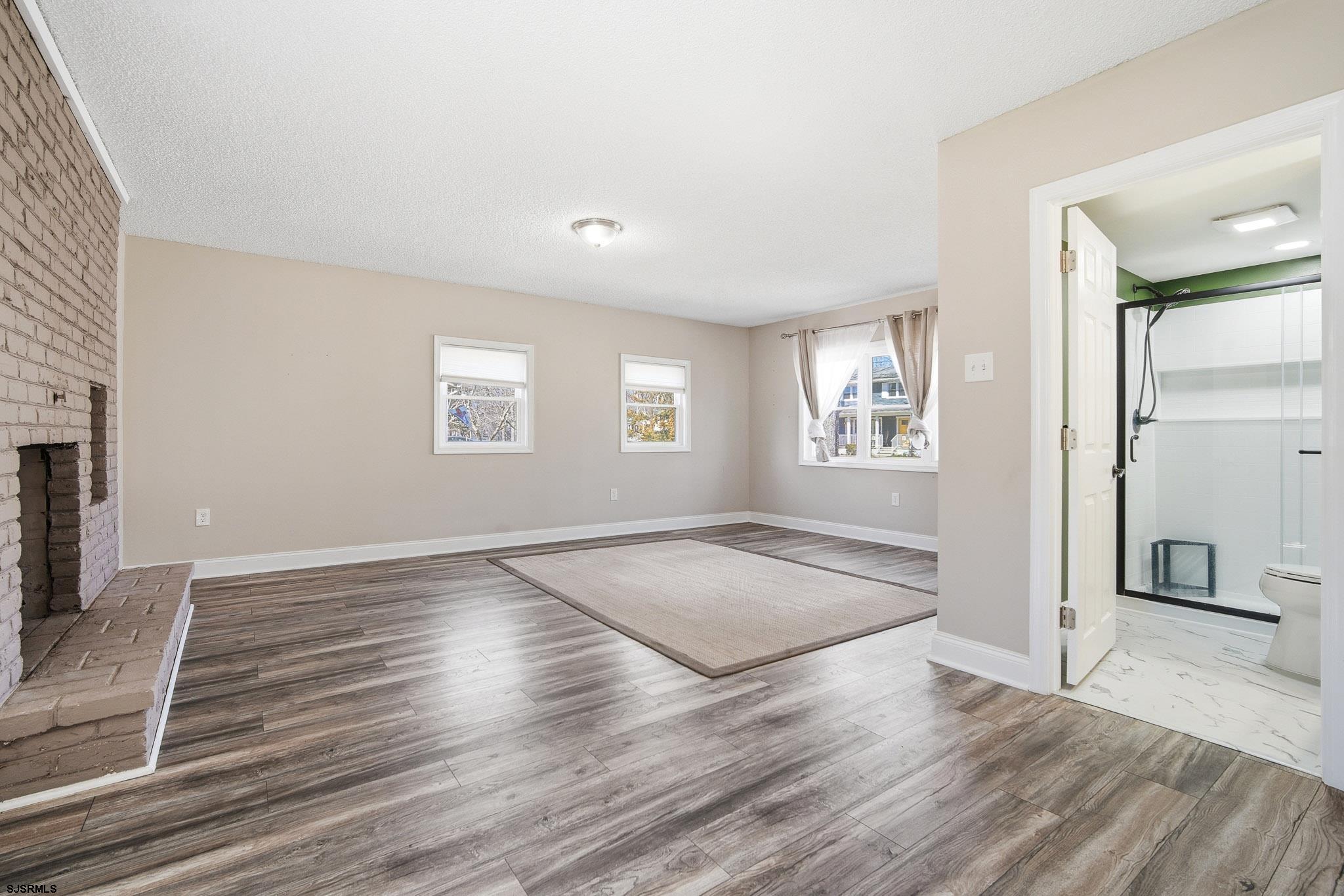 1103 Chelsea Road Absecon, NJ 08201 - Photo 15 of 34 an empty room with wooden floor and windows