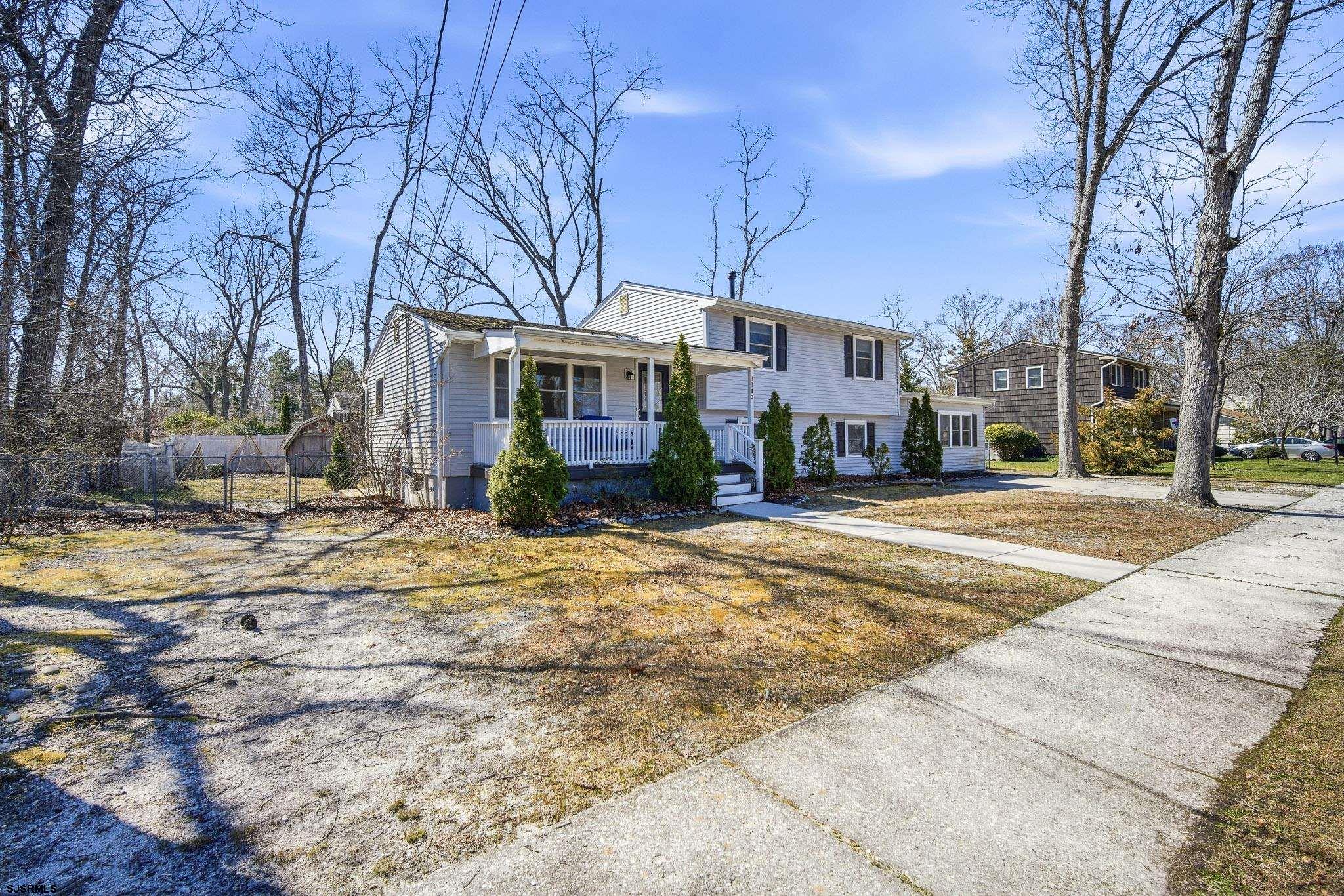 1103 Chelsea Road Absecon, NJ 08201 - Photo 2 of 34 a front view of a building with a yard