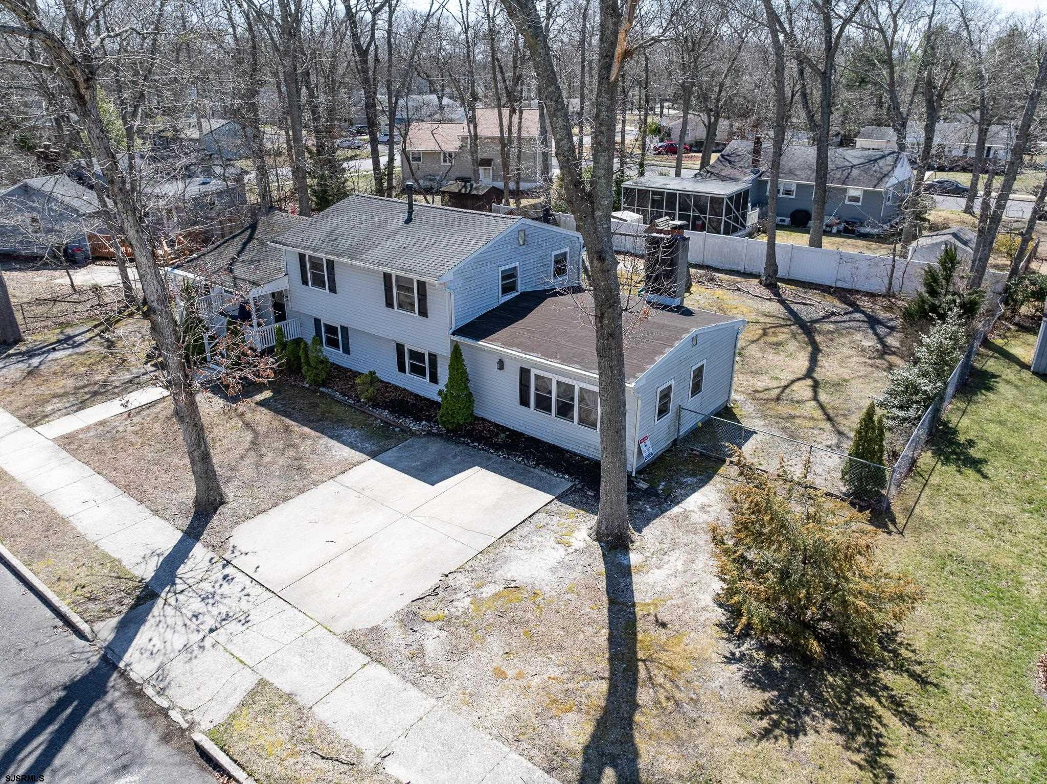 1103 Chelsea Road Absecon, NJ 08201 - Photo 29 of 34 a view of a house with large wooden deck and sitting area