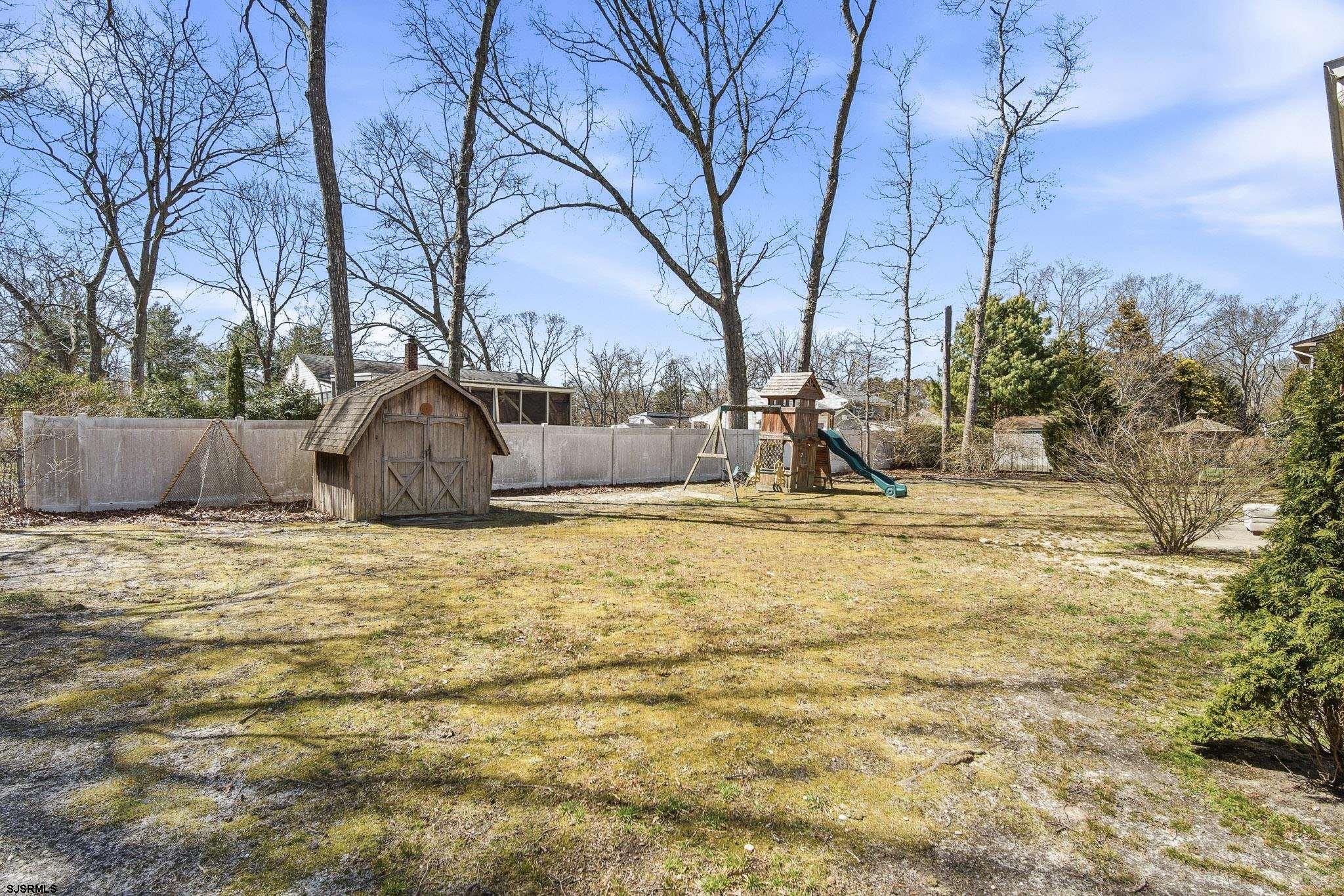 1103 Chelsea Road Absecon, NJ 08201 - Photo 3 of 34 a backyard of a house with lots of green space