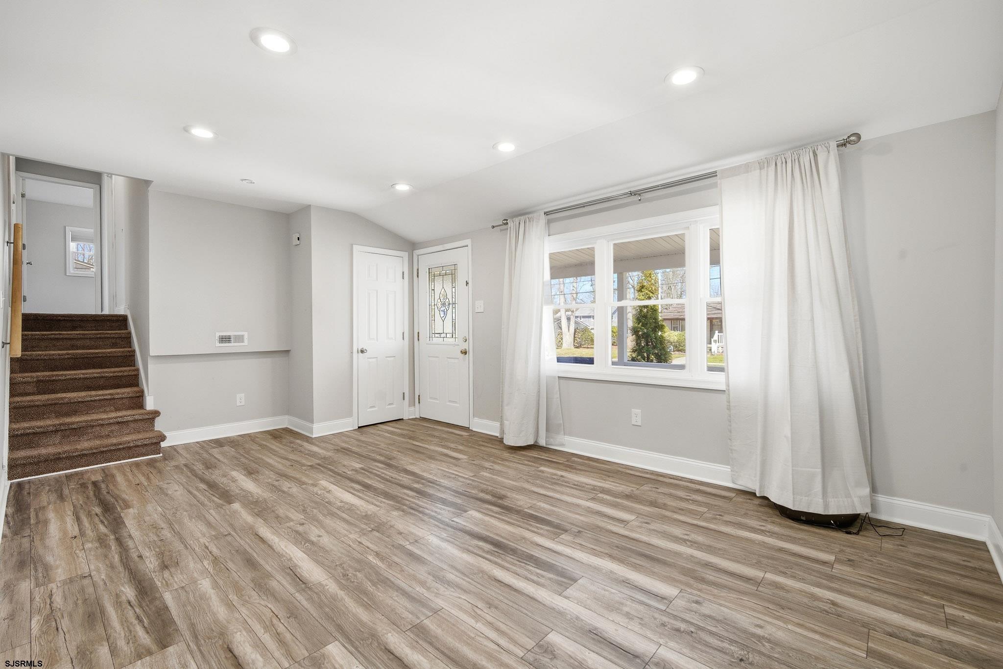1103 Chelsea Road Absecon, NJ 08201 - Photo 7 of 34 a view of an empty room with wooden floor and a window
