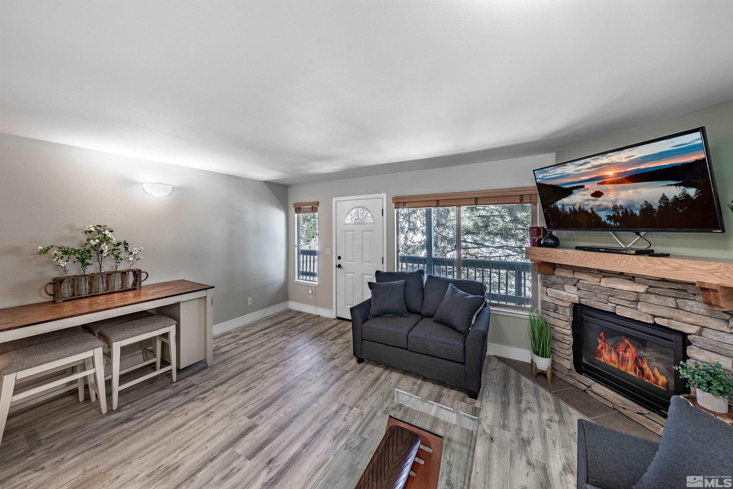 360 Galaxy Lane, Unit 2 (B) Stateline, NV 89449 - Photo 2 of 22 a living room with furniture a flat screen tv and a fireplace