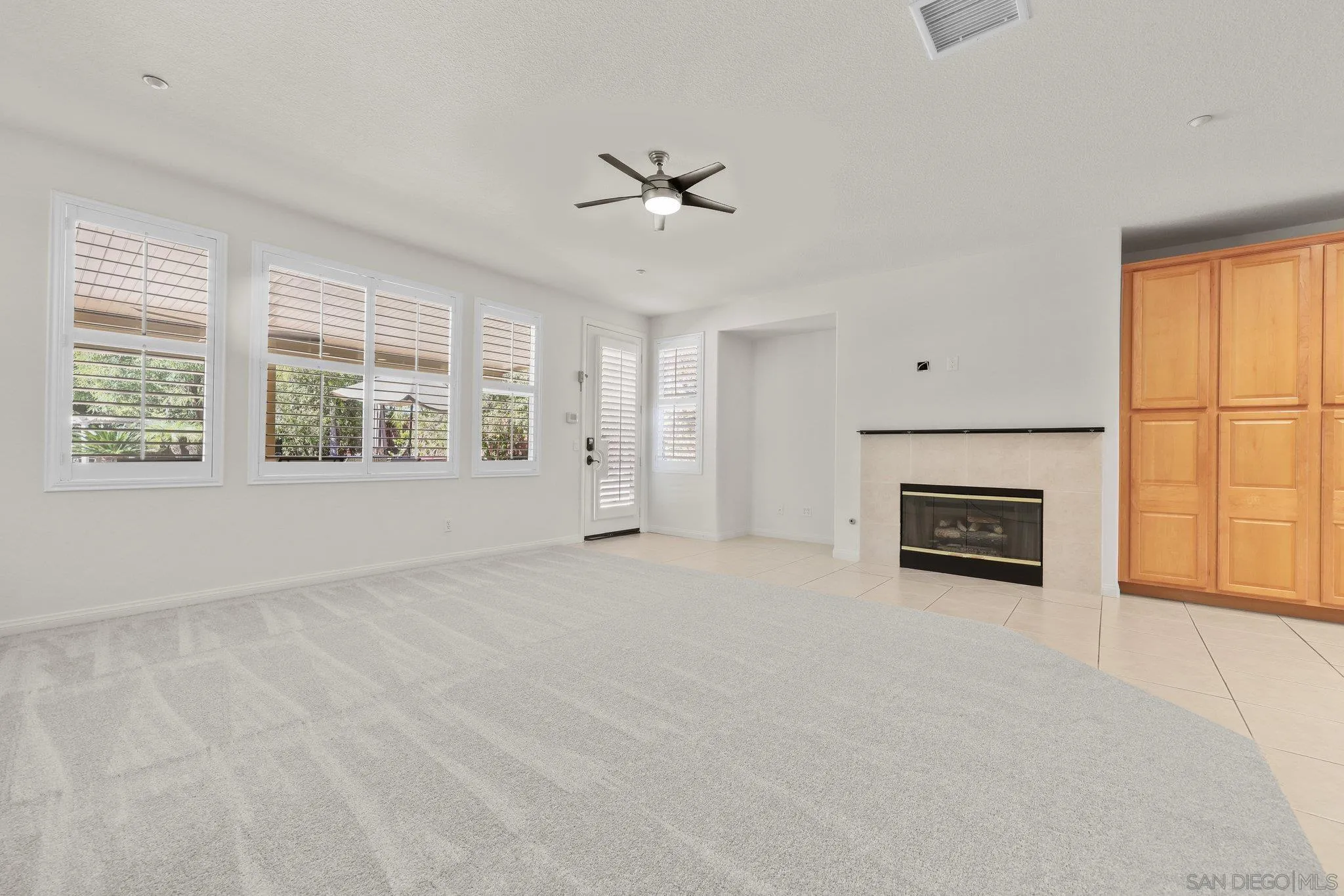 824 Hillcrest Terrace Fallbrook, CA 92028 - Photo 11 of 47 an empty room with windows and fireplace