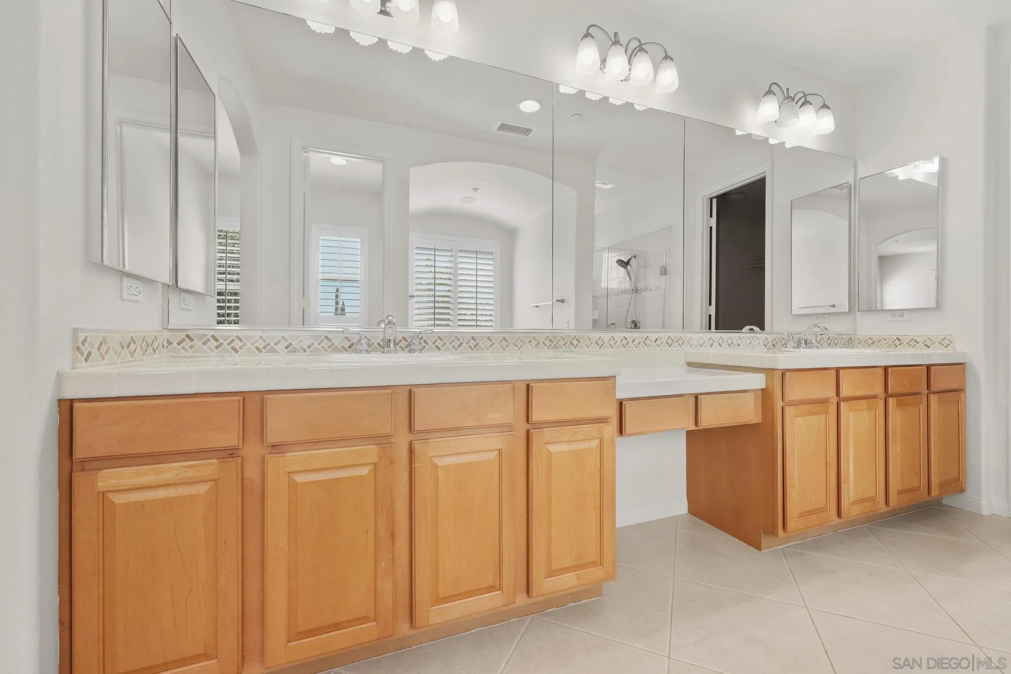 824 Hillcrest Terrace Fallbrook, CA 92028 - Photo 20 of 47 a bathroom with a granite countertop sink and a mirror