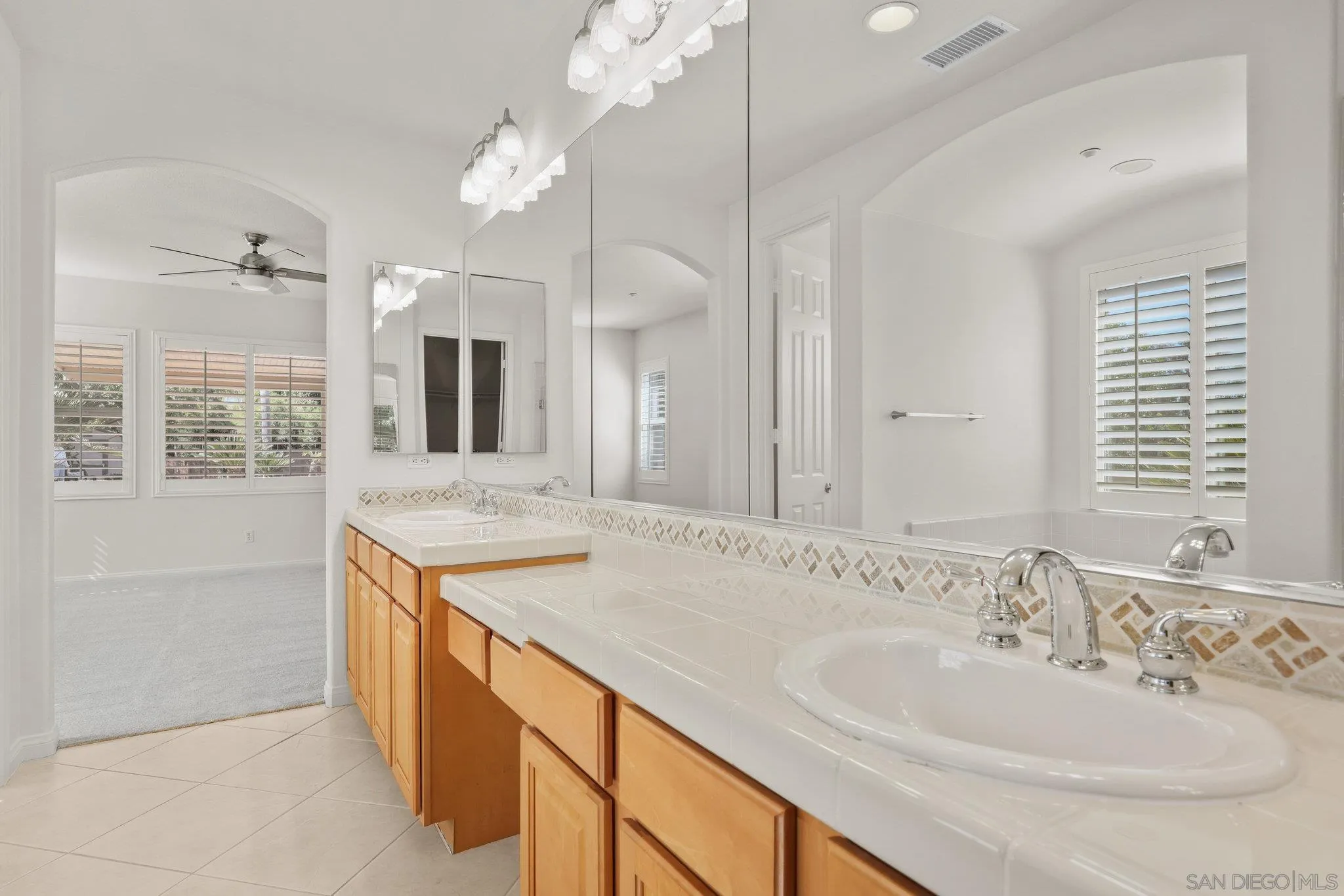 824 Hillcrest Terrace Fallbrook, CA 92028 - Photo 23 of 47 a bathroom with a sink and a mirror