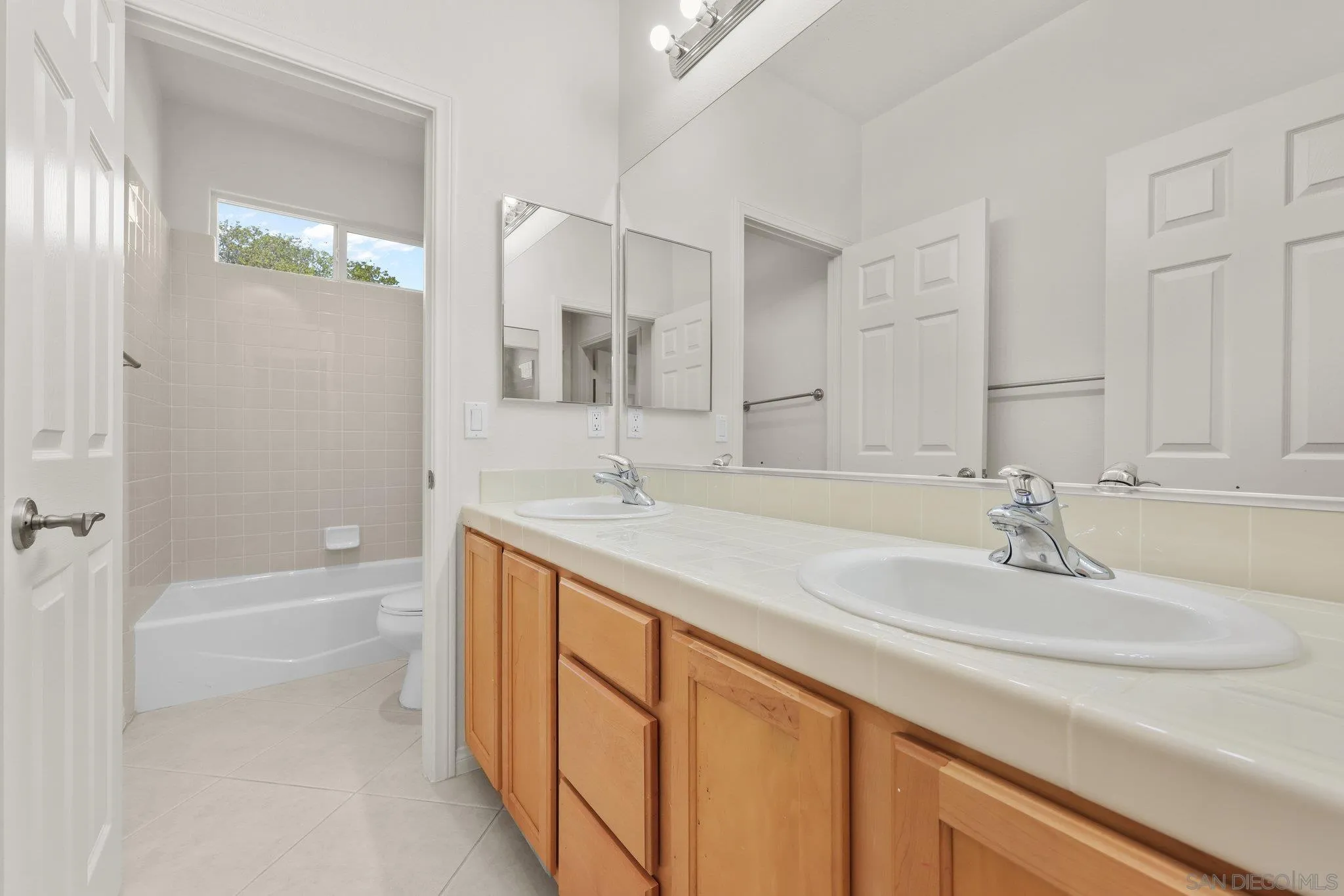 824 Hillcrest Terrace Fallbrook, CA 92028 - Photo 28 of 47 a bathroom with a sink double vanity granite tub shower and a mirror