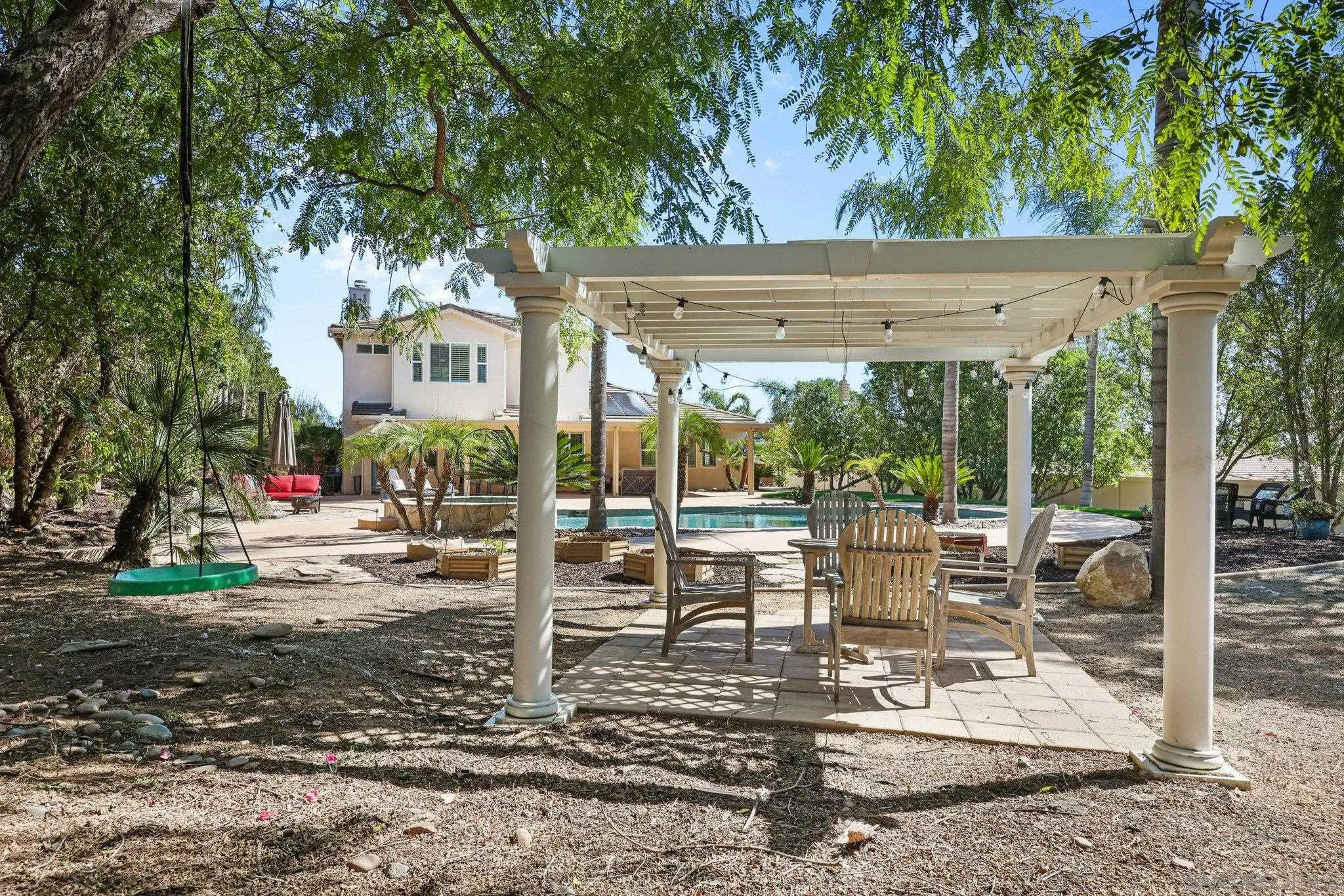 824 Hillcrest Terrace Fallbrook, CA 92028 - Photo 39 of 47 a view of a patio with table and chairs potted plants and large tree