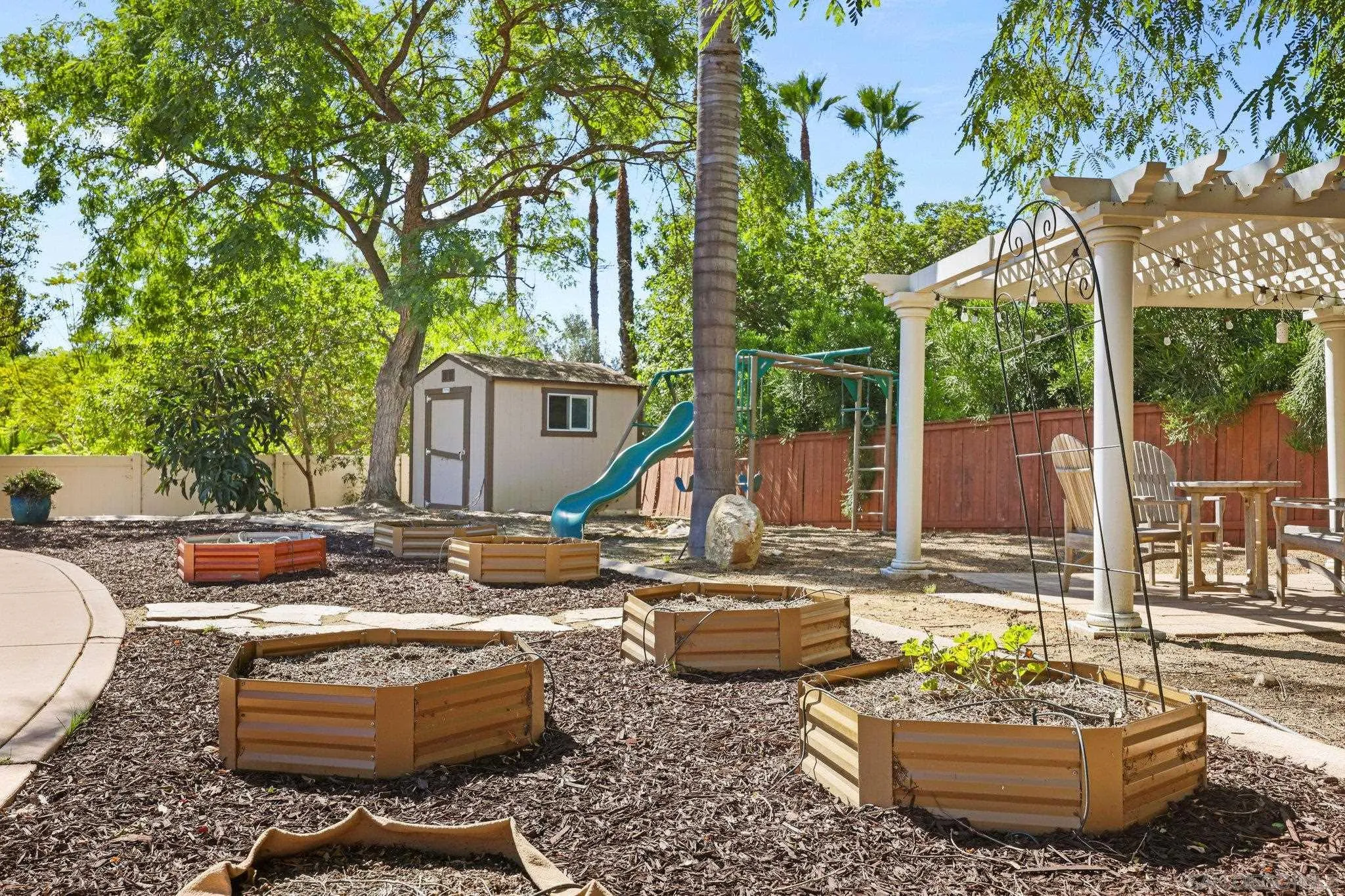 824 Hillcrest Terrace Fallbrook, CA 92028 - Photo 40 of 47 a view of a patio with couches table and chairs and potted plants
