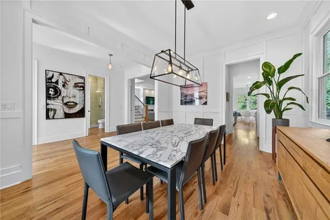 a view of a dining room with furniture and wooden floor