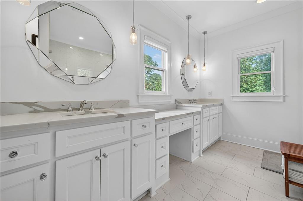 3110 Skyland Drive Northeast Chamblee, GA 30341 - Photo 20 of 43 a spacious bathroom with a double vanity sink mirror and a bathtub