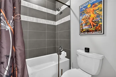 a bathroom with a toilet and a bathtub