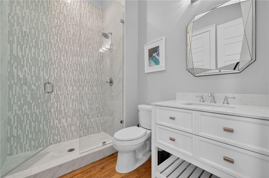 3110 Skyland Drive Northeast Chamblee, GA 30341 - Photo 27 of 43 a bathroom with a toilet a sink a mirror and shower