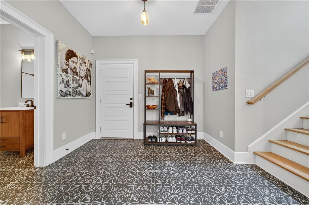 3110 Skyland Drive Northeast Chamblee, GA 30341 - Photo 34 of 43 a view of a hallway with wooden floor and a dining table