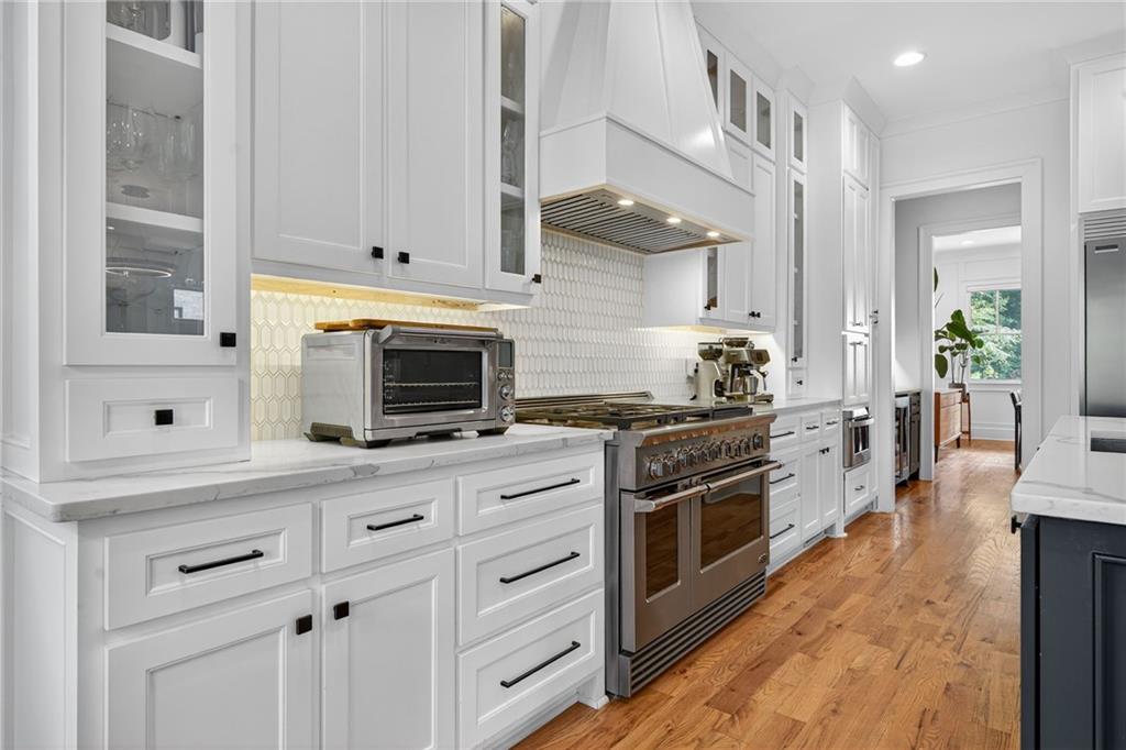 3110 Skyland Drive Northeast Chamblee, GA 30341 - Photo 9 of 43 a kitchen with cabinets stainless steel appliances and a wooden floor